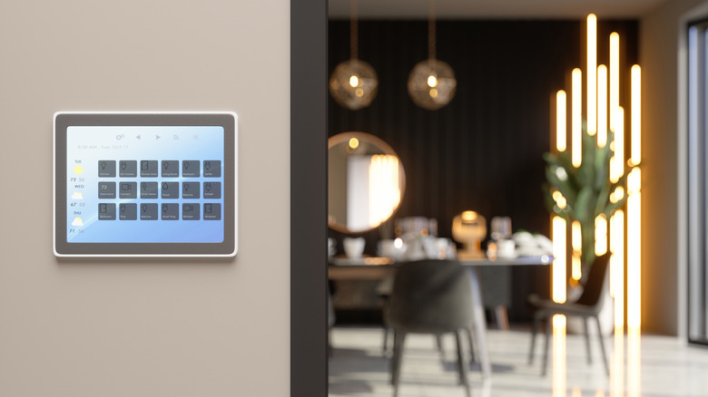 Smart Home Control System With App Icons On A Digital Screen In Dining Room With Blurred Background