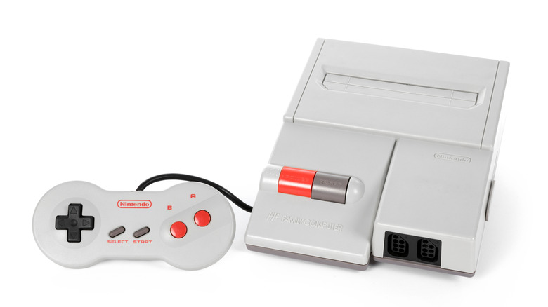 a Nintendo AV Famicom with a controller against a white background