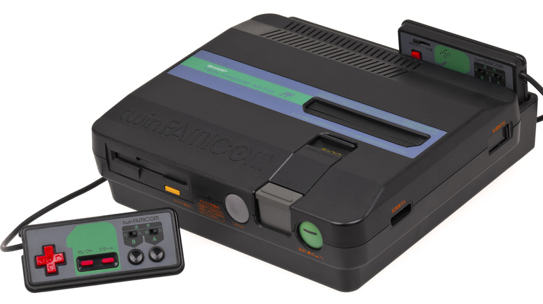 A Sharp Twin Famicom with two controllers on a white background