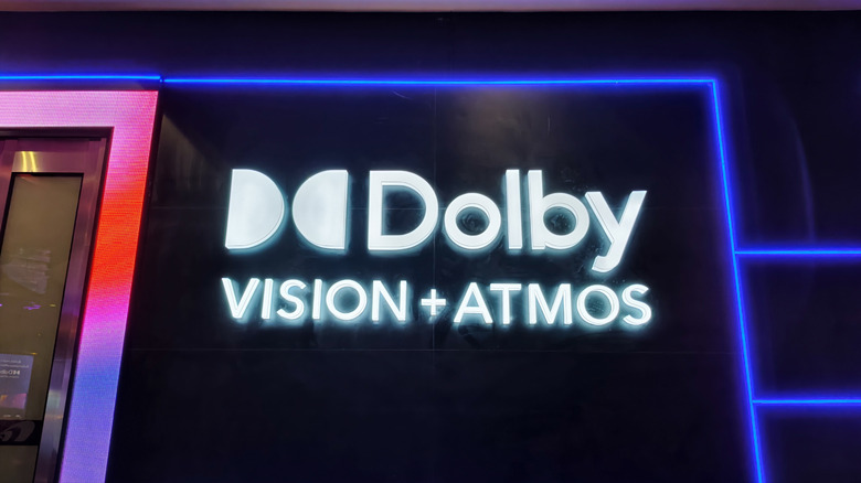 Dolby Vision and Dolby Atmos logo on side of wall with neon lights.