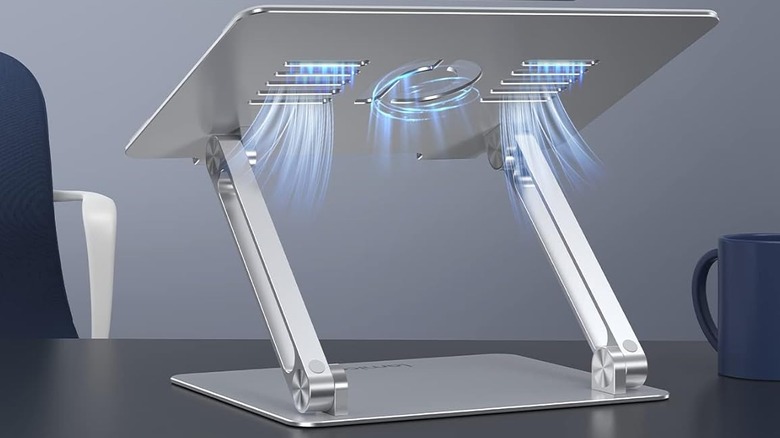 The Lamicall Laptop Stand set up on a table beside a coffee mug.