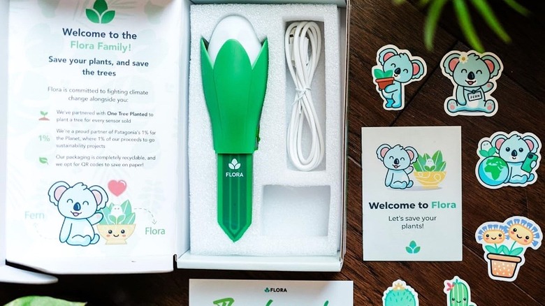 Flora Pod USB gadget in the box with instructions and charging cable.