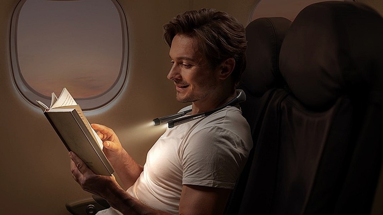 Glocusent ergonomic reading and book light used on a plane.