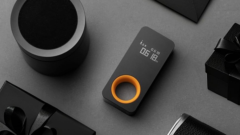 HOTO digital laser measurement tool on counter.