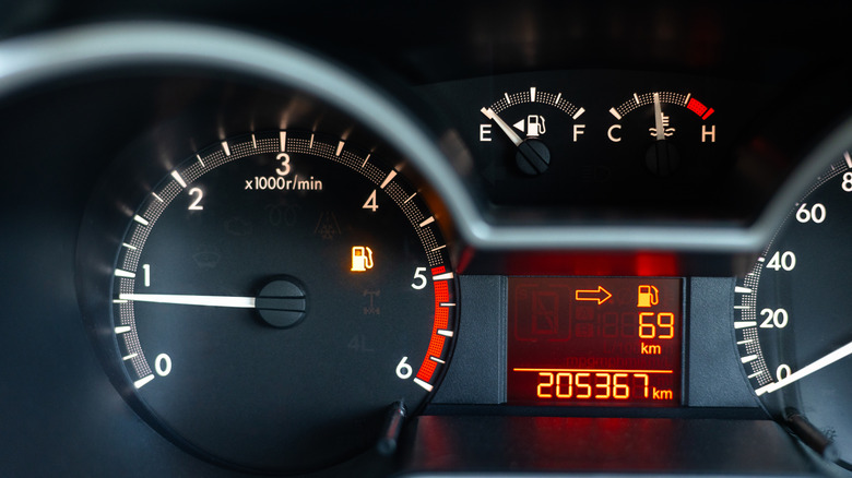 Close-Up of car dashboard displaying KM driven, speedometer, and other gauges