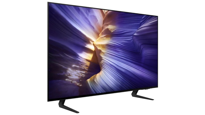 Samsung S90F OLED side view showing a purple and orange rock formation on a white background