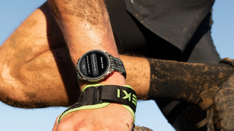 The arm of a man bending down on a trail while wearing the Amazfit Cheetah 2 Ultra.