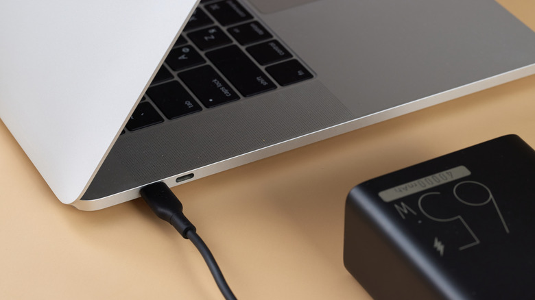 A MacBook charging from a power bank.