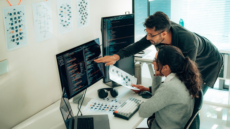 Two programmers working together in an office.