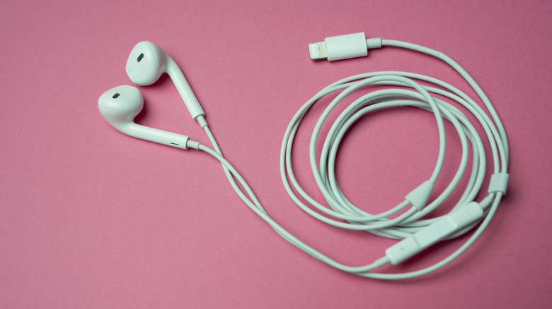 Wired Apple EarPods on a pink background