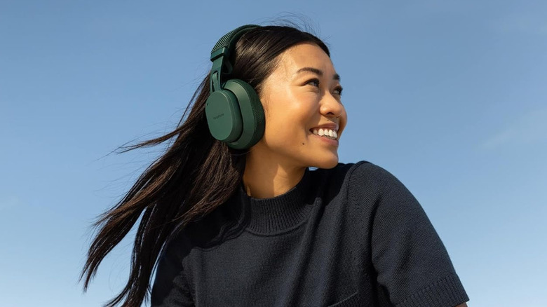 A woman wearing the Fairphone Fairbuds XL wireless headphones