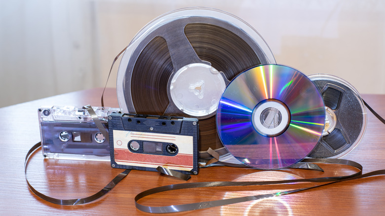Cassette tapes, film, and a CD sitting together on a table