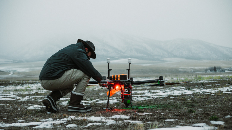 An engineer preps a cloud-seeding drone
