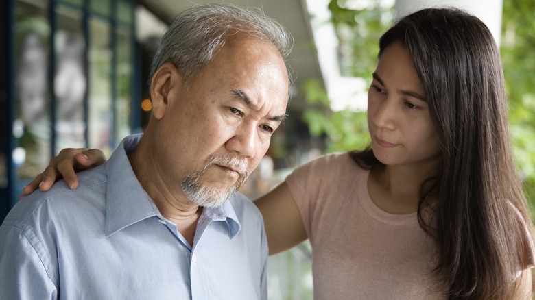 a daughter cares for her father with Alzheimer's