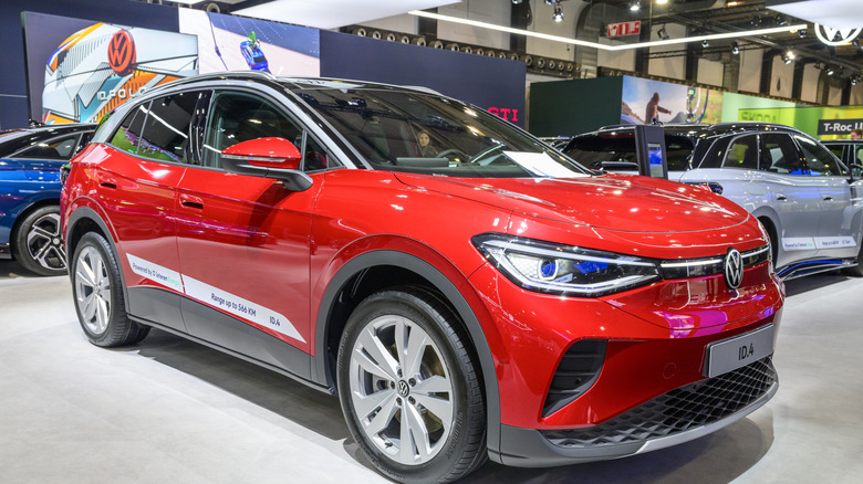 A red Volkswagen ID.4 electric SUV in a showroom