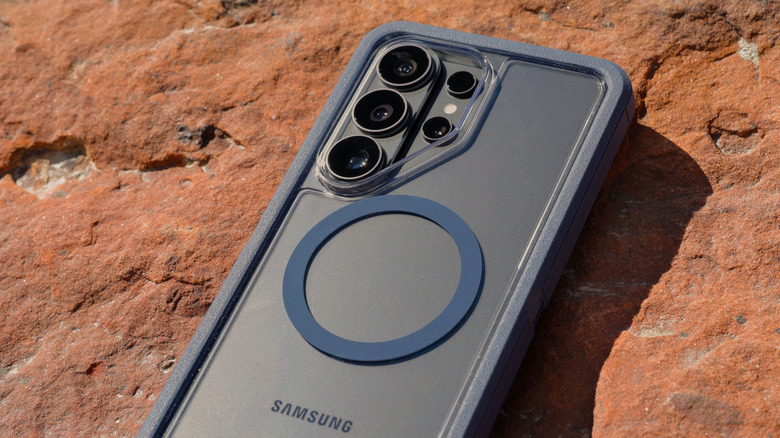 The Samsung Galaxy S26 Ultra with the Otterbox Defender Series Pro XT case on a stone surface