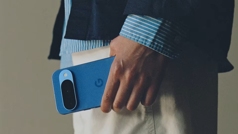 Hand holding blue Google Pixel 10
