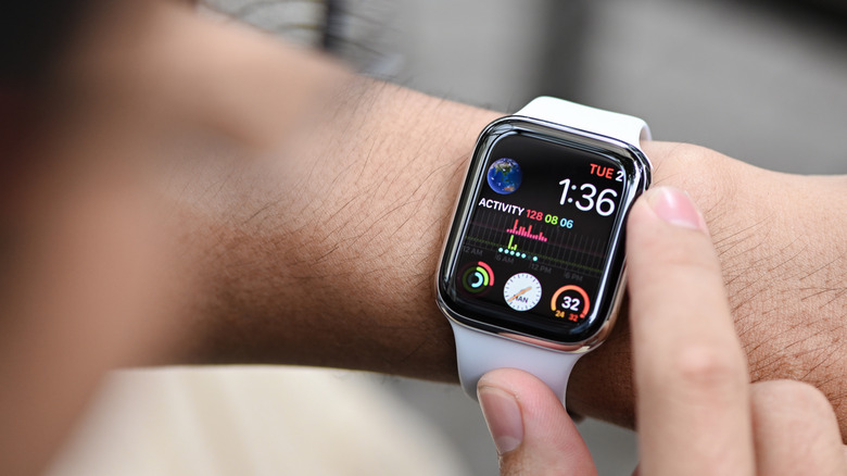 Close-up of a person interacting with an Apple Watch Series 4 worn on their wrist