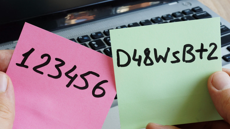 Passwords written down on sticky notes and held by someone.