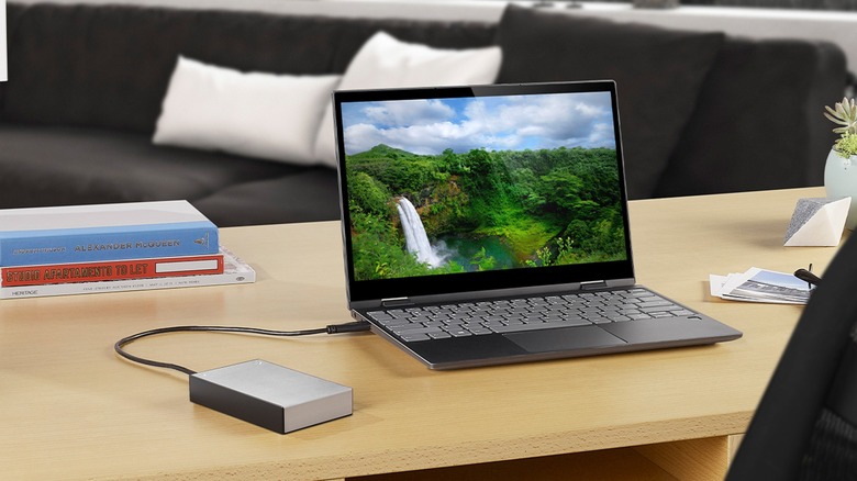 External Seagate One Touch hard drive connected to laptop on desk