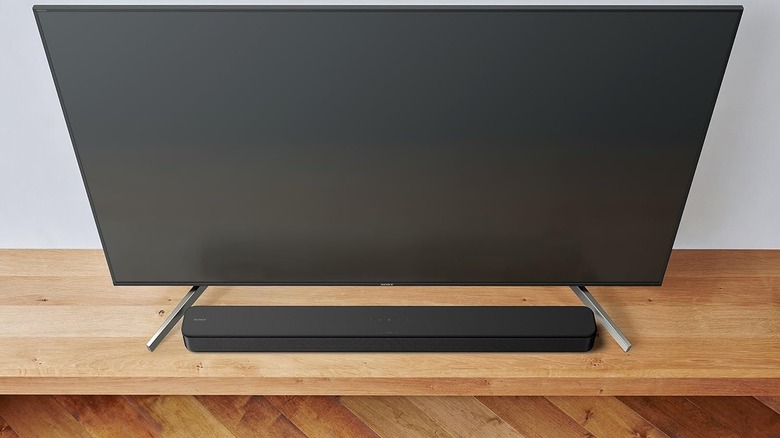 The Sony HTS100F Soundbar set up below a tabletop TV.