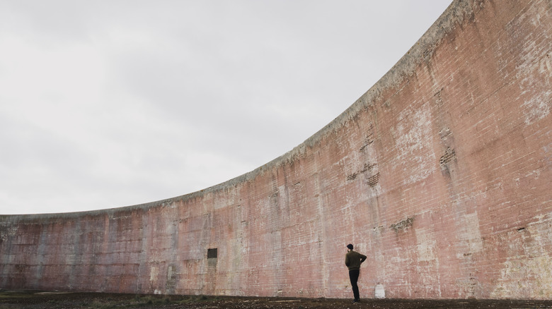 The larger Denge Sound Mirror with a person in front for scale