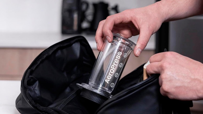 The AeroPress Clear Coffee Press being placed in a bag.