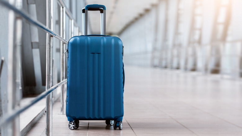 blue piece of luggage in an airport
