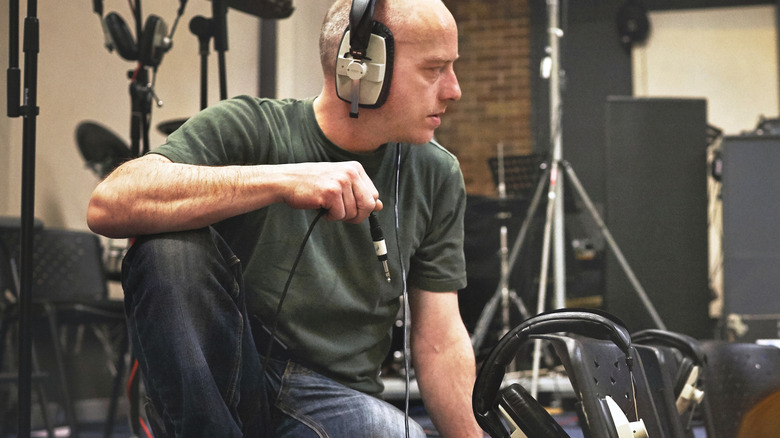 An audio technician with a pair of wired headphones