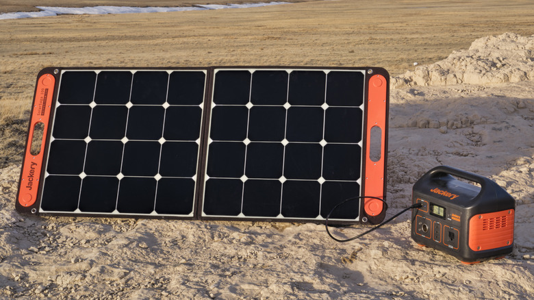 A portable solar panel being used to charge a power station.
