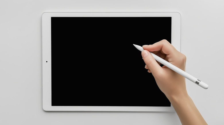 User tapping the iPad blank screen with Apple Pencil to start a new note.