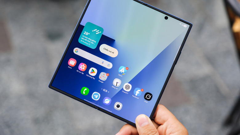 Someone holding an open Galaxy Z Fold 7 with one hand.