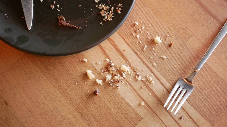 A tabletop full of crumbs.
