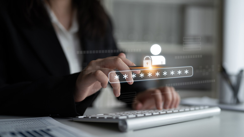 A business woman is typing at a keyboard, a holographic password prompt hovers in front of her.