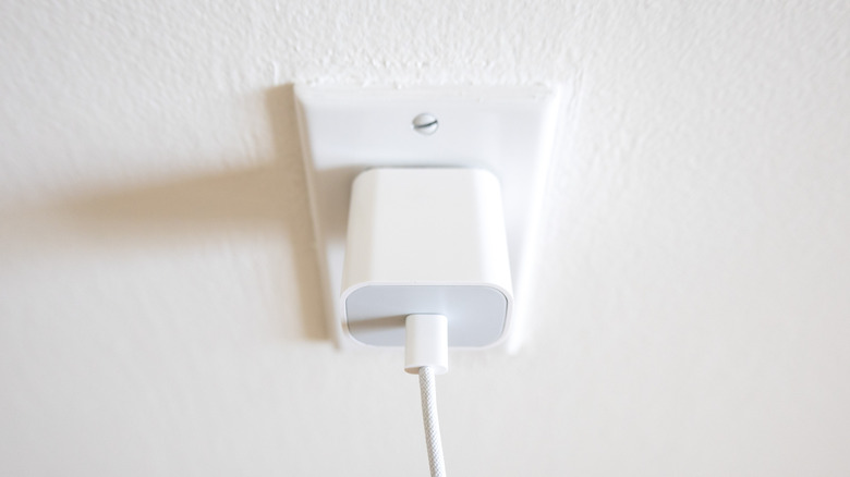 a white phone charger plugged into the wall
