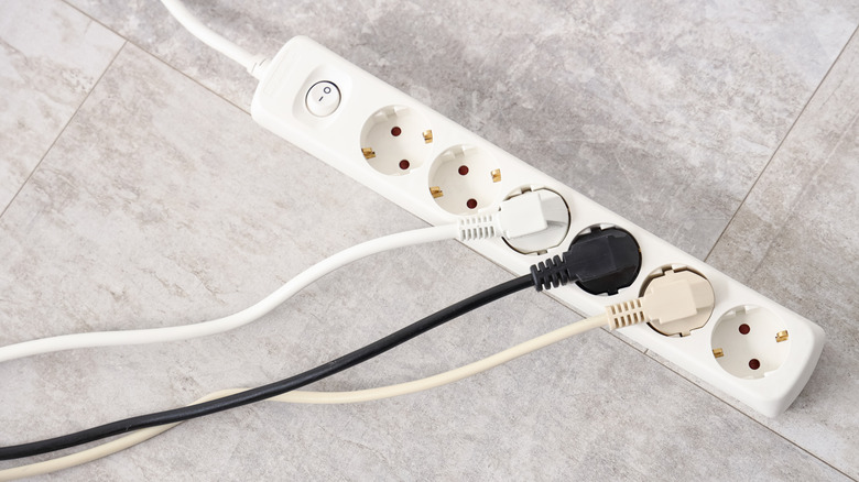 Plugs inserted into a UK extension cord power strip