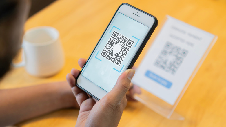 person scans a QR code on their phone