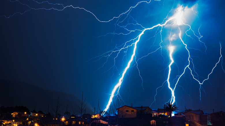 lightning strikes around a neighborhood during a thunderstorm