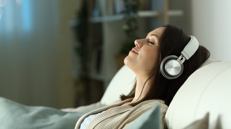 A young woman asleep with headphones on.