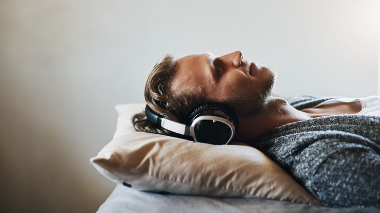 a man sleeping with headphones on