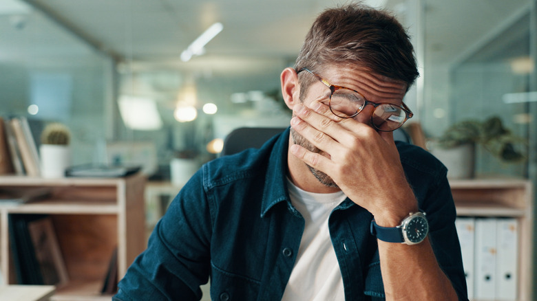 a man is really tired at work from not sleeping well