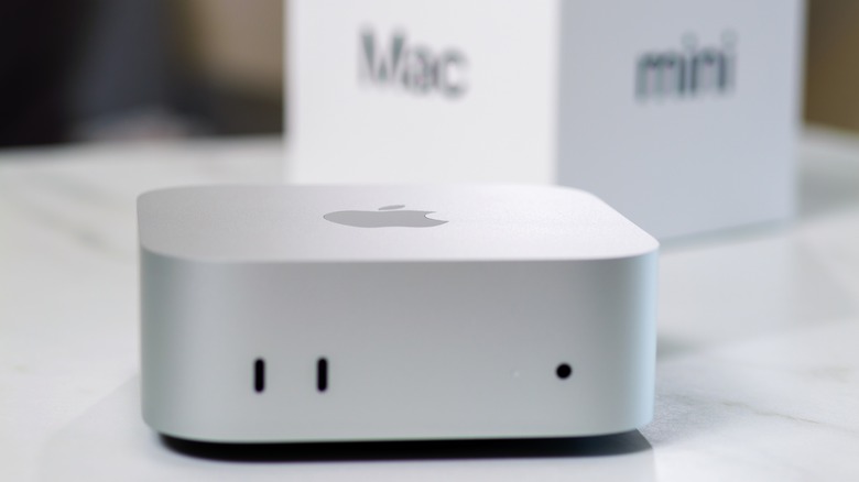 An Apple Mac Mini with packaging in the background