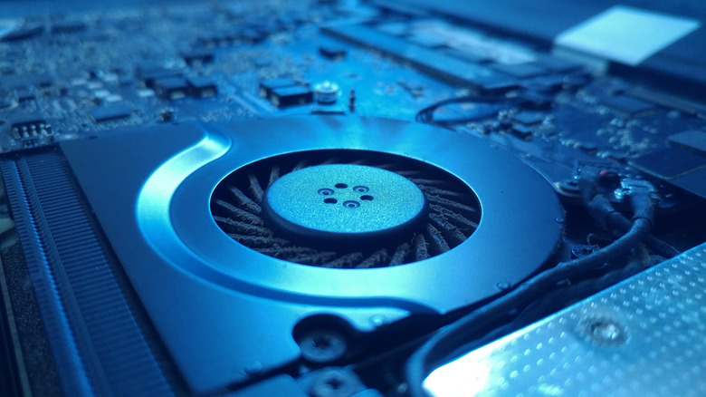 A photograph emphasizing a laptop's cooling fan