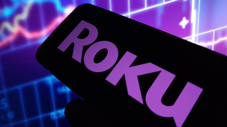 A Roku logo on a mobile app with abstract background