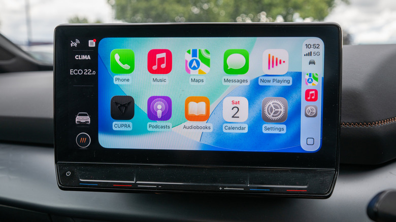An infotainment screen on top of a vehicle's dash displaying the CarPlay home screen