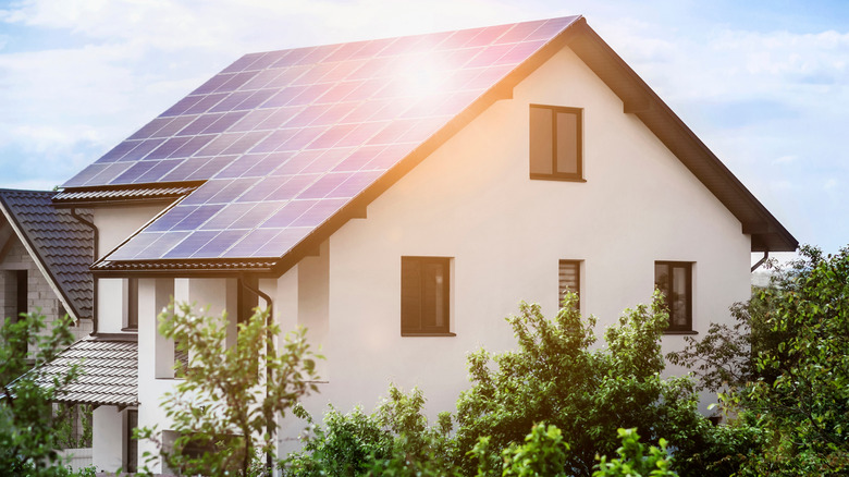 Sunlight reflected on the solar panels of a house's roof.