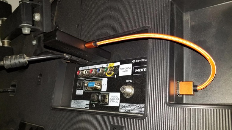Orange USB cable plugged into TV and streaming stick