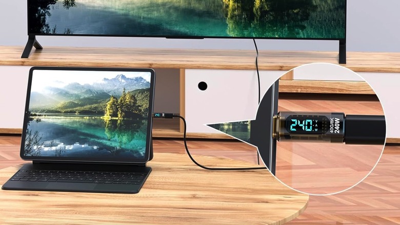 A tablet connected to a display/TV with the power meter measuring the power draw.