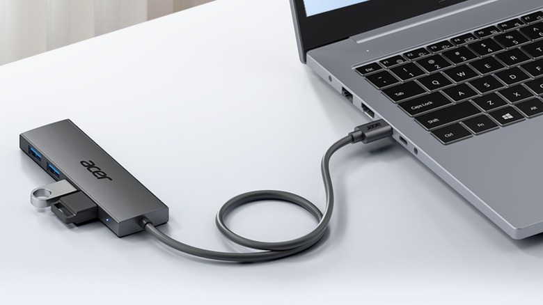 An Acer USB Hub with flash drives plugged in connected to an Apple laptop