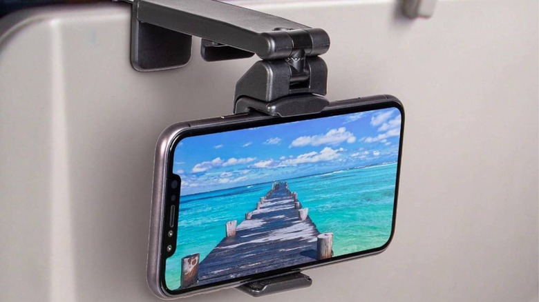 close-up of Perilogics phone mount holder attached to back of airplane seat
